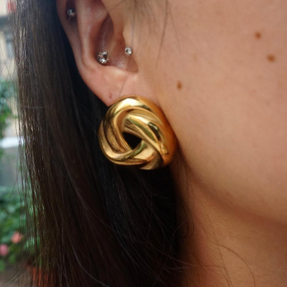 Model in statement studs in triangle shape