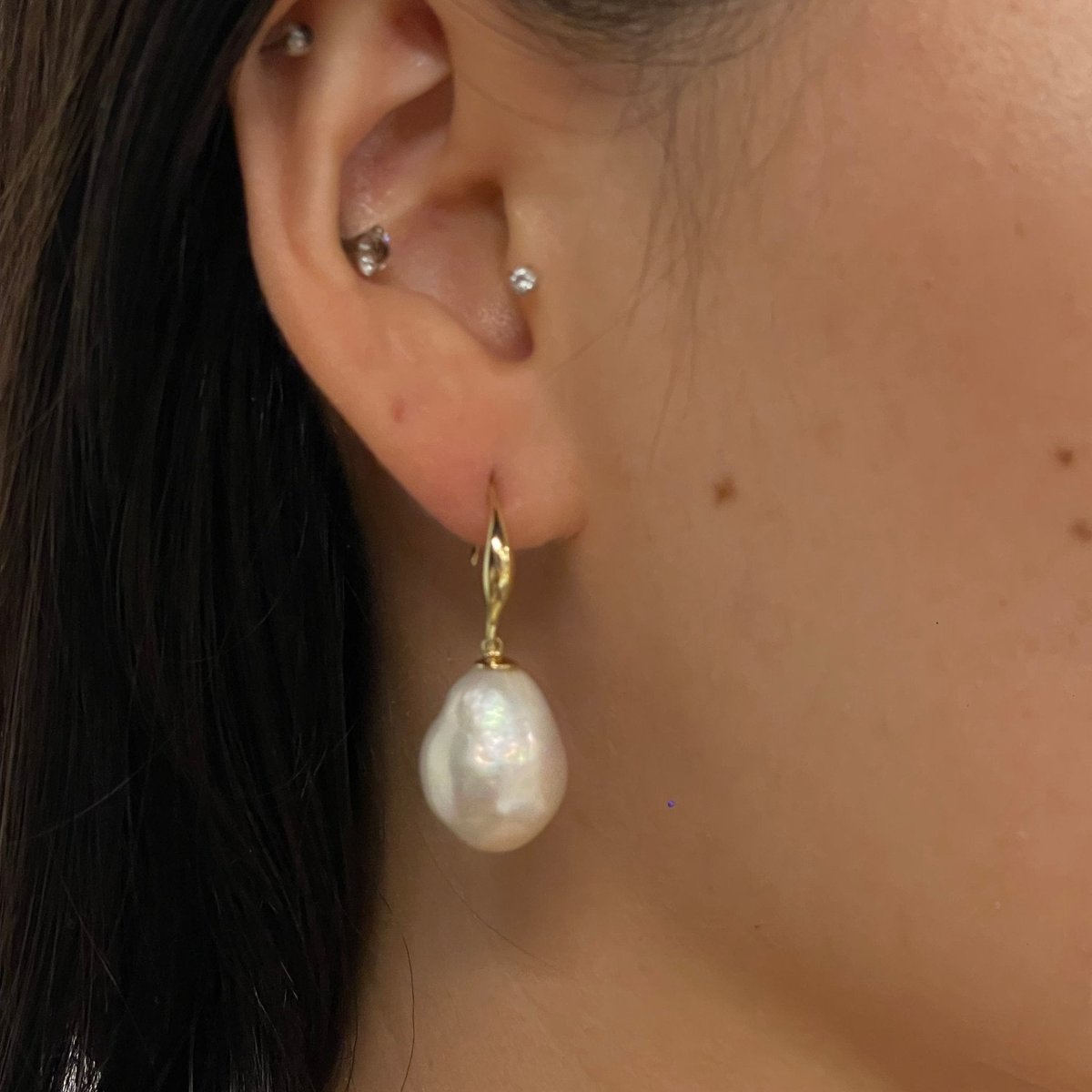 Model in Single Baroque Pearl Fish Hook Earrings